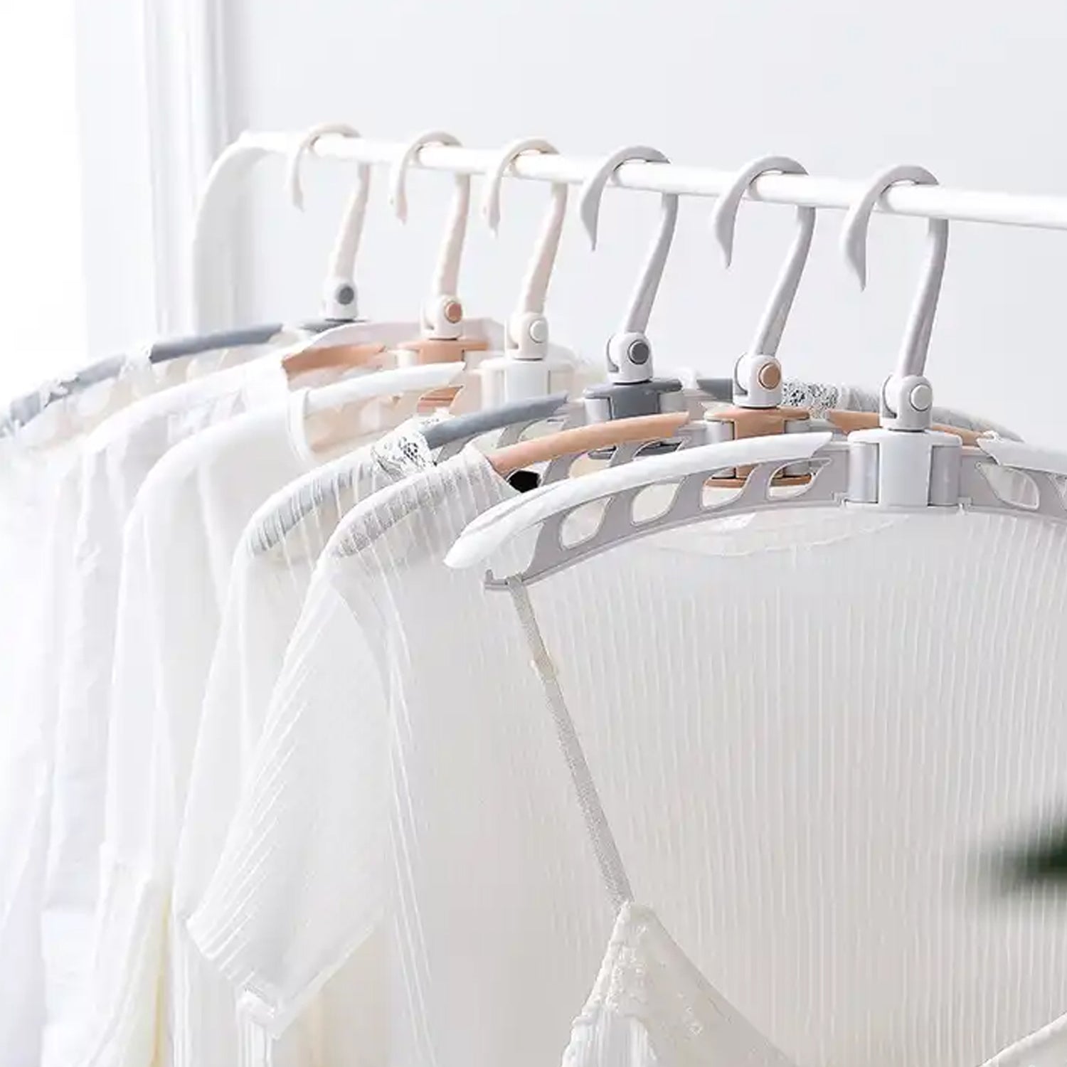 Adjustable arms of the folding clothes hanger demonstrated.
