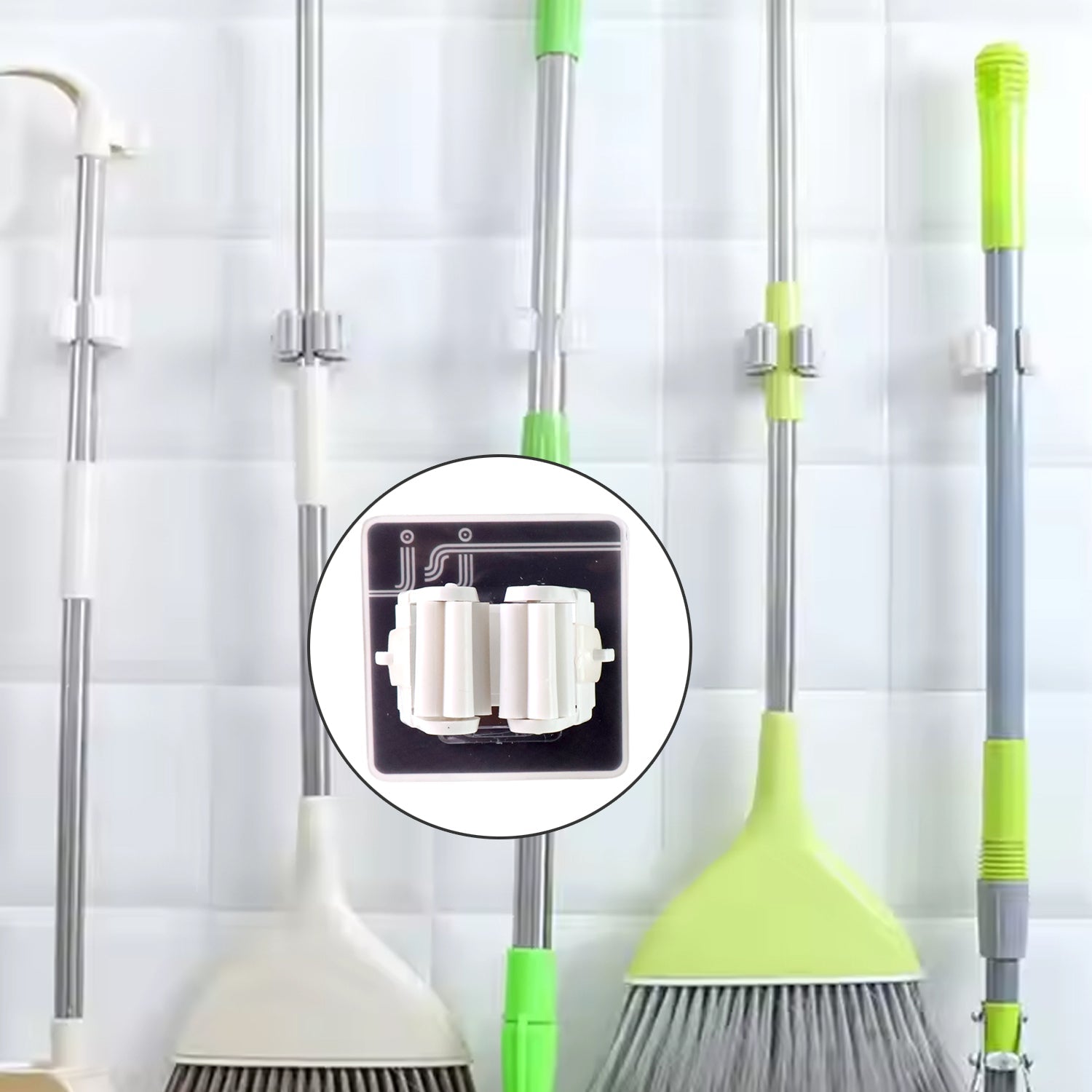 Single adhesive mop holder securely holding a mop on a wall.