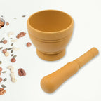 Hand-crushing fresh herbs using a durable mortar and pestle.