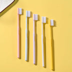 Arrangement of multicolor soft plastic toothbrushes, showcasing the variety in the family pack.