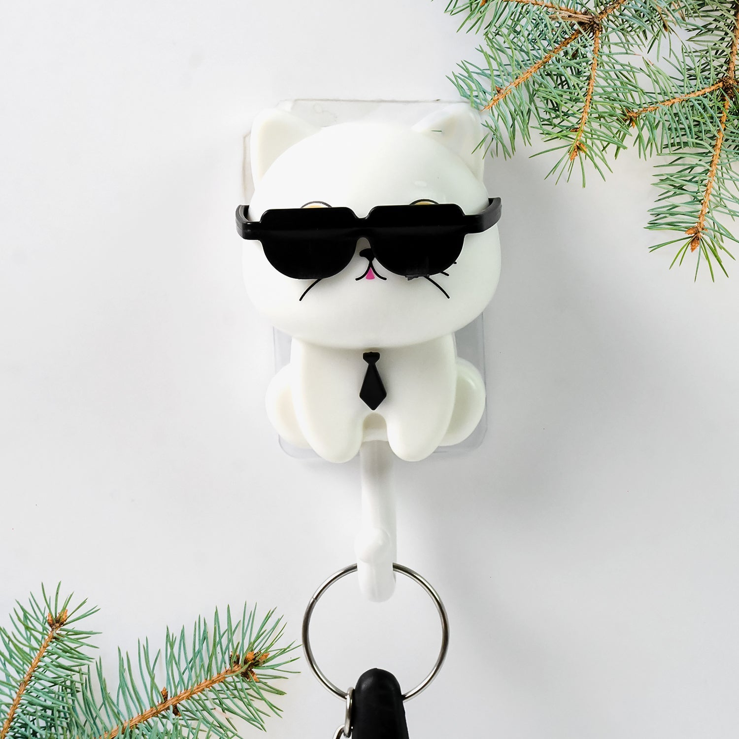 Detailed view of the cute cat face and interactive sunglasses feature on the wall hook.