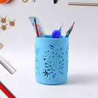 Front angle shot of plastic mesh pen holder organizing pens and pencils