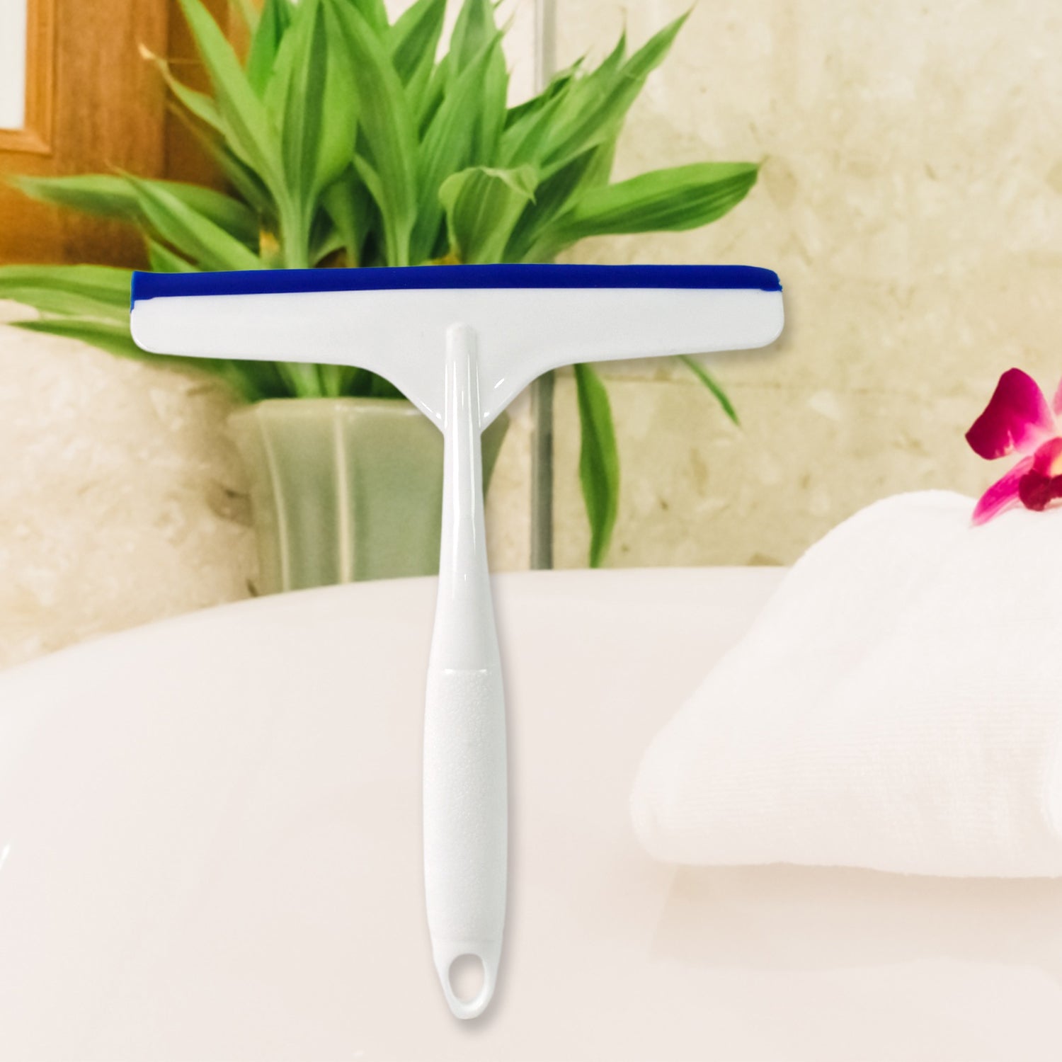 Ergonomic white kitchen wiper held by hand, ready for cleaning.