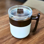 Insulated mug featuring a comfortable ergonomic handle for easy grip.