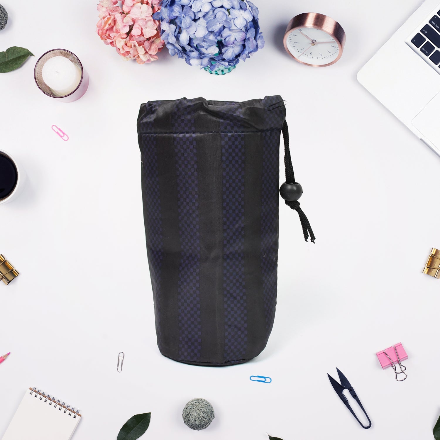 Multipurpose rope organizer holding pens and pencils, demonstrating its spacious interior.