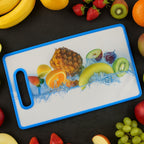 Large cutting board with decorative fruit print and blue edge