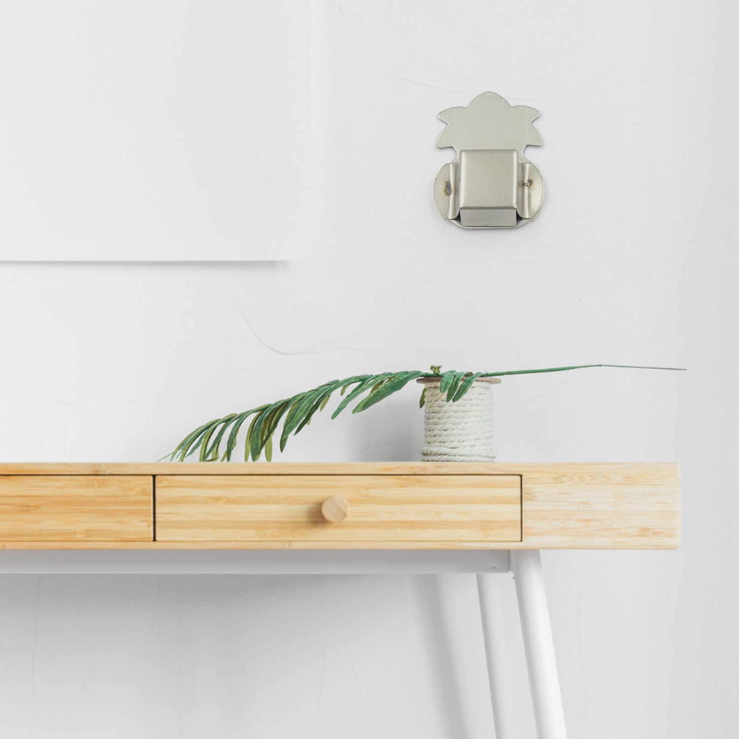 Sleek stainless steel agarbatti stand mounted on a wall.