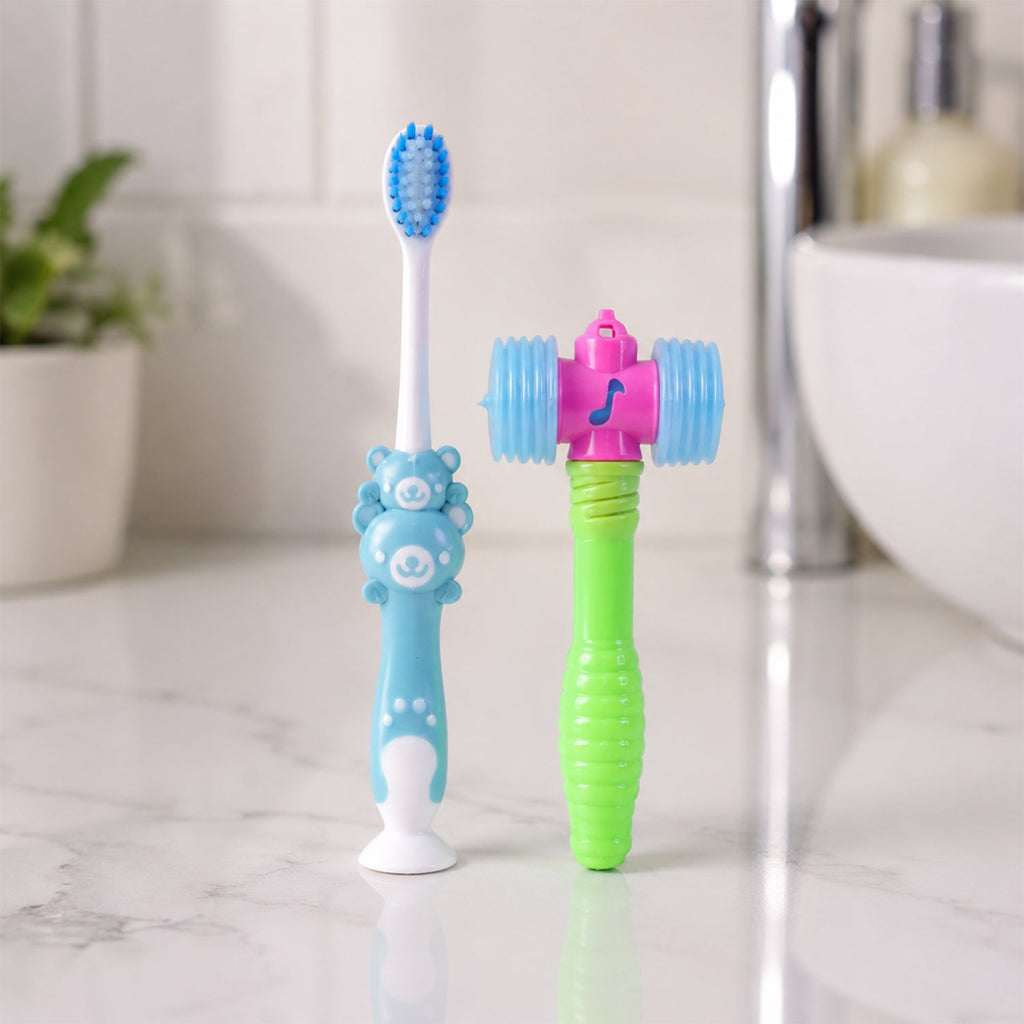 Kids' manual toothbrush and toy hammer on white surface