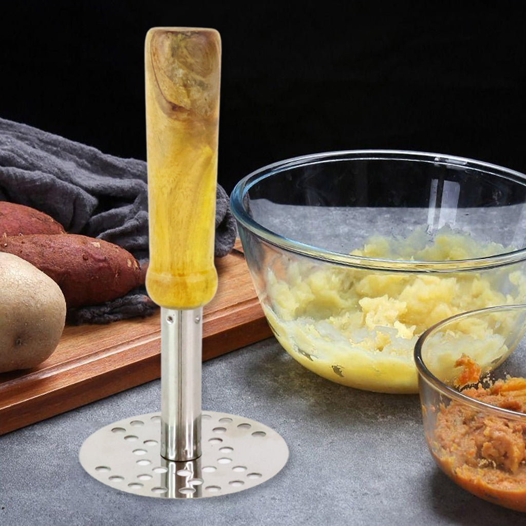 Stainless Steel Potato Masher resting beside a bowl of freshly mashed potatoes.
