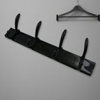 Top-down view of the 4-hook wall mount coat hanger holding various coats and hats.