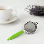 Stainless steel tea and coffee strainer with a sturdy handle.