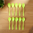 Several lightweight plastic spoons stacked, showing their compact and space-saving design.