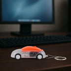 Close-up of Mini Car LED Keychain Light showing glowing LED headlights