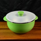 Ergonomic serving bowl with side handles and vented plastic lid