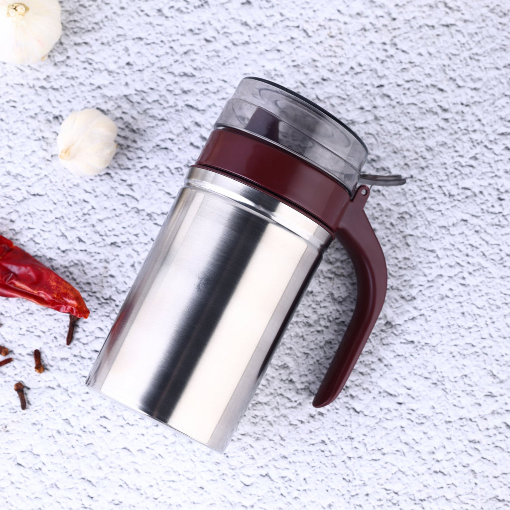 Sleek stainless steel oil dispenser with a small pouring nozzle on a white background.