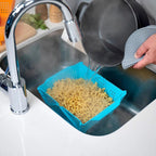 Foldable storage basket used in a modern kitchen setting for pantry organization.