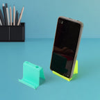Side angle view of plastic mobile phone stand with pens and phone in place