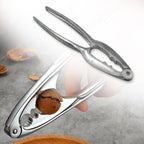 Stainless steel walnut cracker displayed elegantly on a rustic wooden surface.