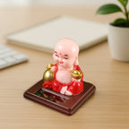 Solar Buddha Car Ornament placed on a car dashboard, adding a serene touch to the vehicle's interior.