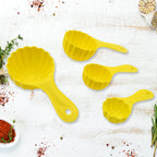 A 4-piece plastic ladoo making spoon set, displayed with an additional serving spoon.