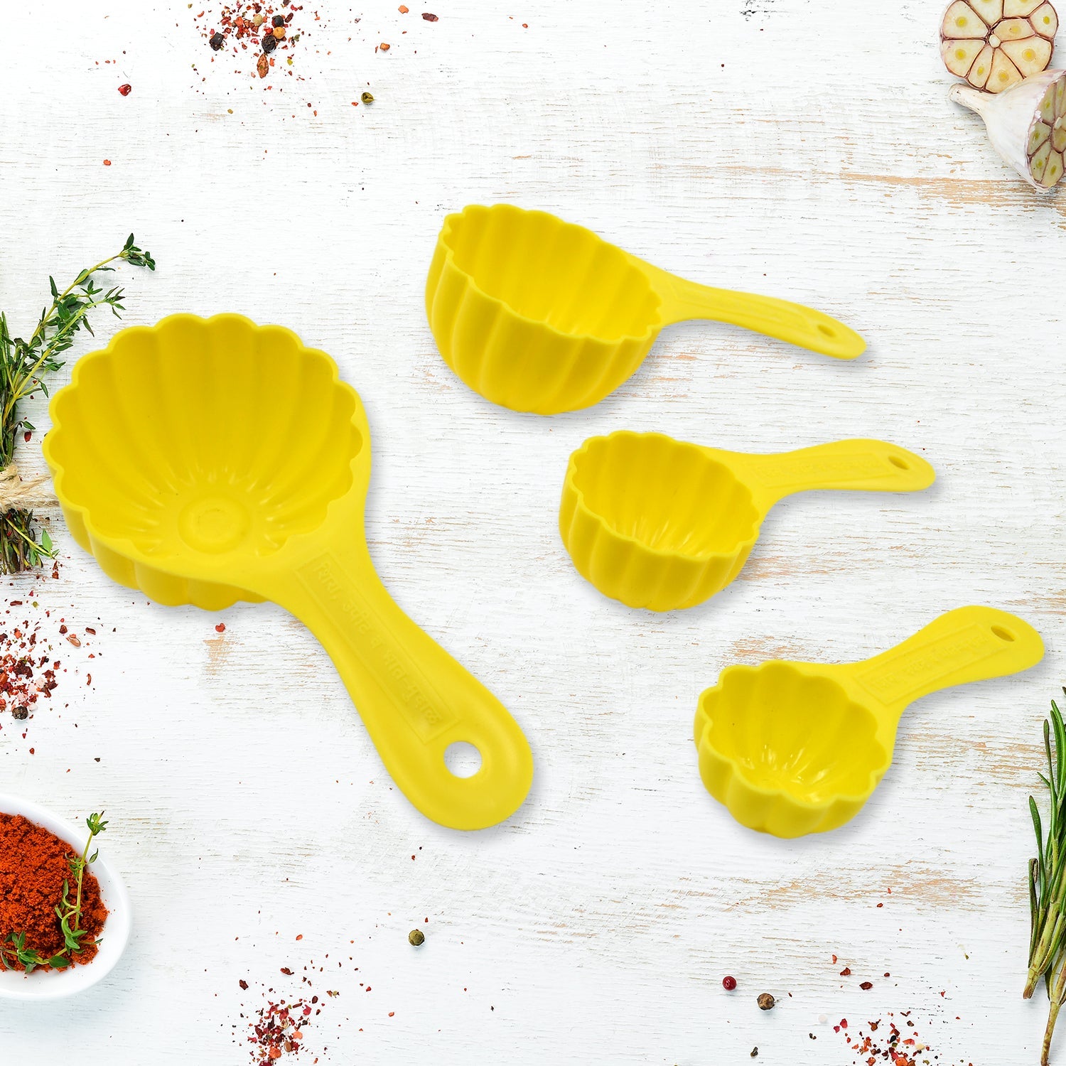 A 4-piece plastic ladoo making spoon set, displayed with an additional serving spoon.