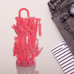 Foldable clothes drying rack with 16 white clips, perfect for delicates.