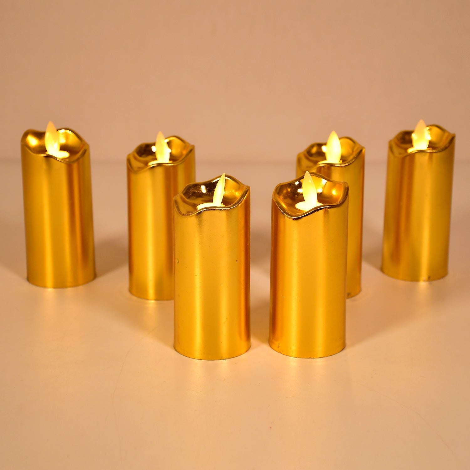 Three elegant golden LED candles creating a warm glow for home decor.