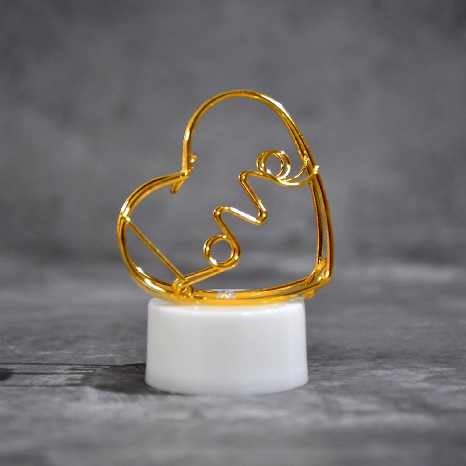 The set of 12 multicolor flameless heart candles displayed in their packaging, ready for gifting or decoration.
