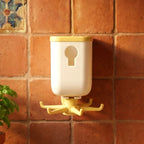 Rotating sticky wall hook attached to a glass surface