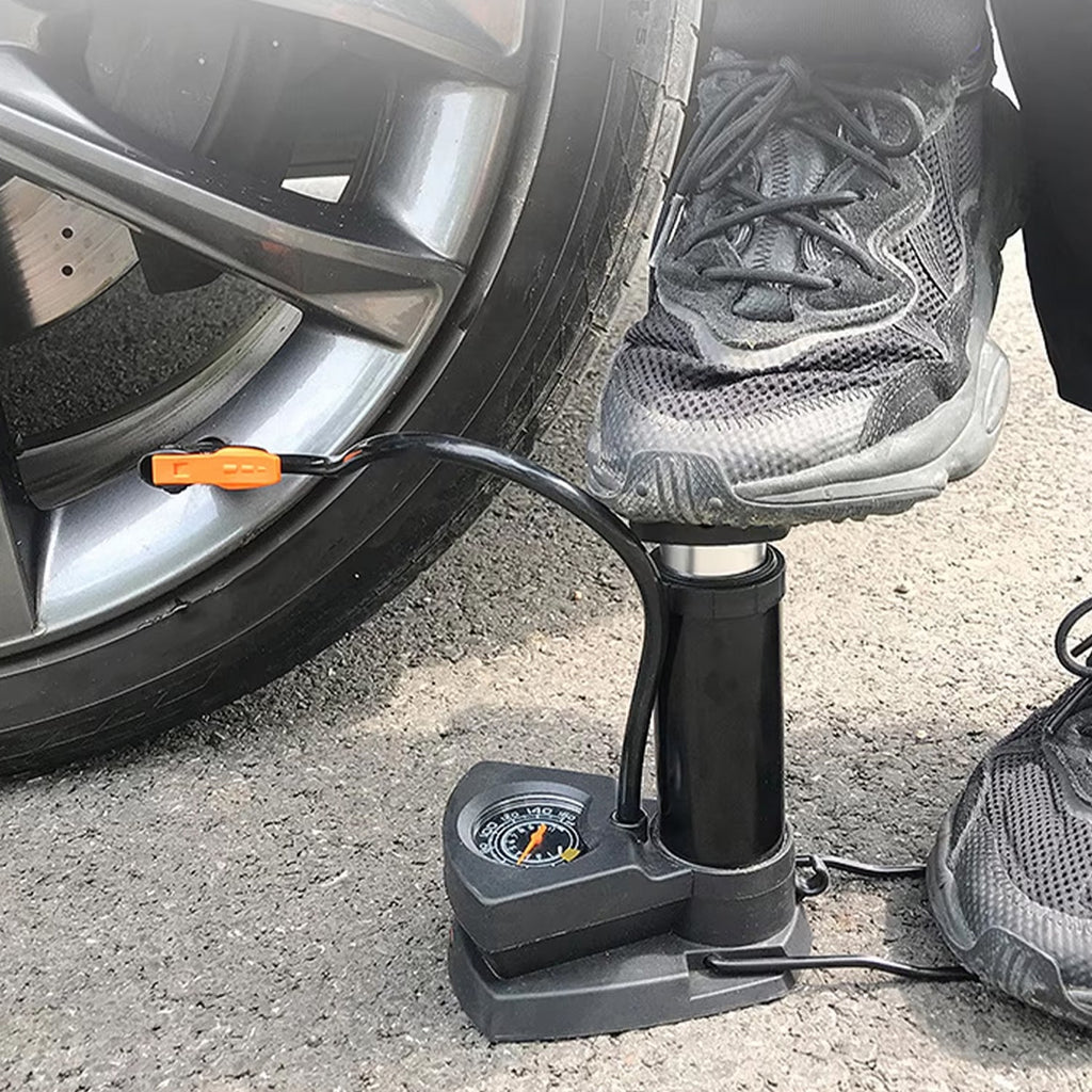 A person using the foot bike pump to quickly inflate a sports ball.