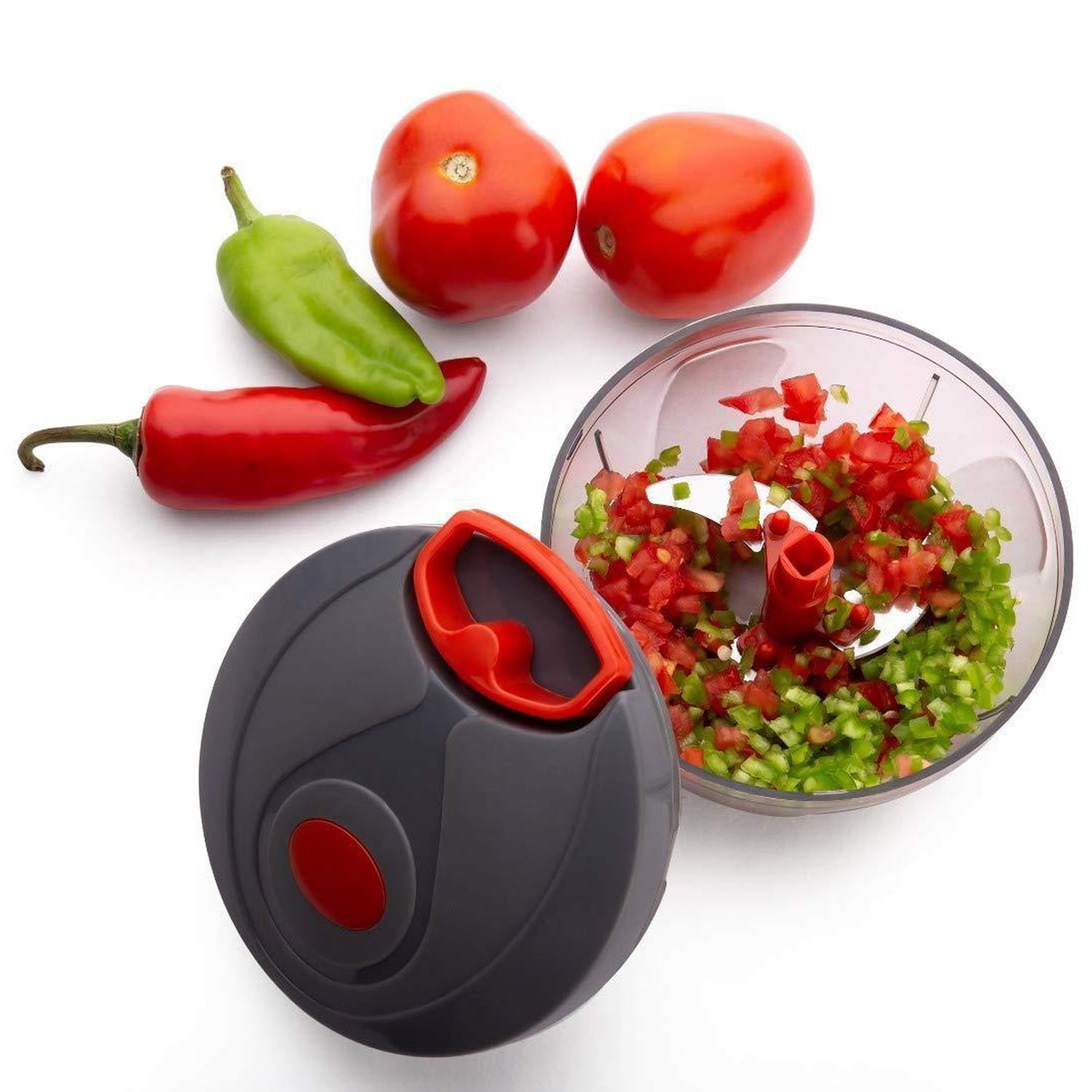 Close-up of the manual food chopper's sharp stainless steel blades inside the clear bowl.