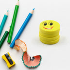 Four vibrant smiley emoji erasers, perfect for kids' school supplies.