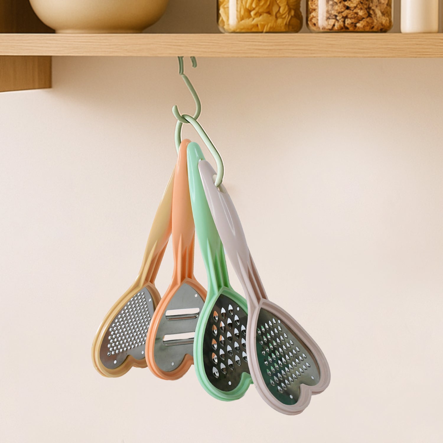 A hand using the heart-shaped grater to effortlessly grate cheese, showcasing its ease of use.