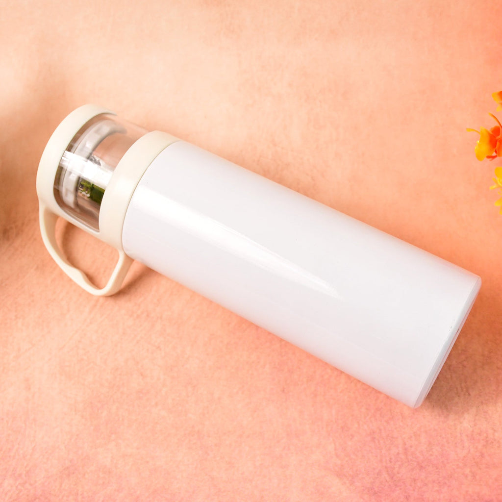 Stainless steel vacuum bottle held in hand showing portable size