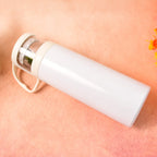 Stainless steel vacuum bottle held in hand showing portable size