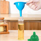 Green silicone funnel making liquid transfer easy in a modern kitchen setup.