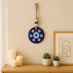 Close-up of blue Evil Eye Wall Hanging charm with beads and natural jute rope