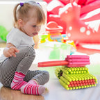 A child happily playing with the intelligent kids construction toy on the floor.