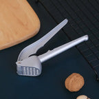 All-aluminum garlic press designed for effortless food preparation.