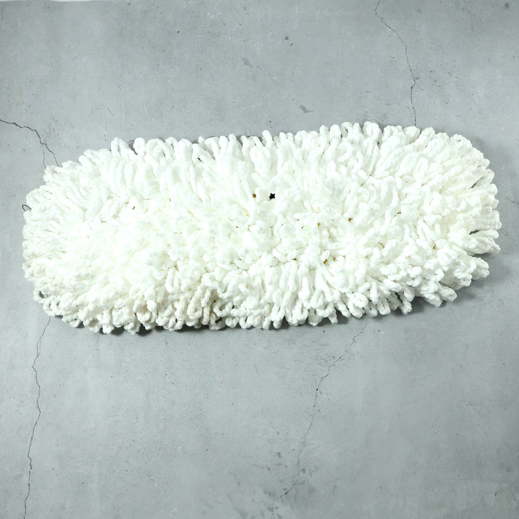 Freshly washed dust mop refill head drying naturally.
