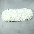 Freshly washed dust mop refill head drying naturally.