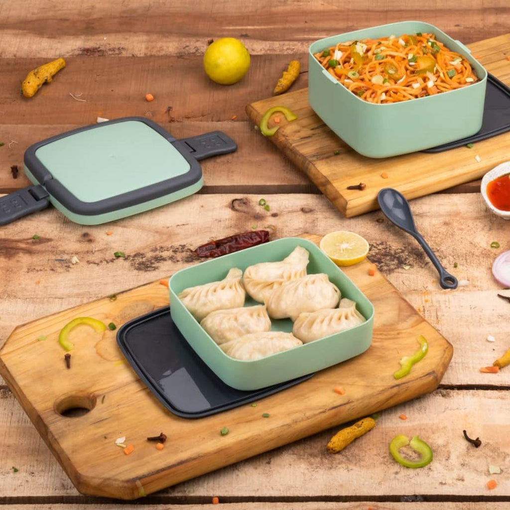 Green stackable lunch box with two layers and a carrying handle.
