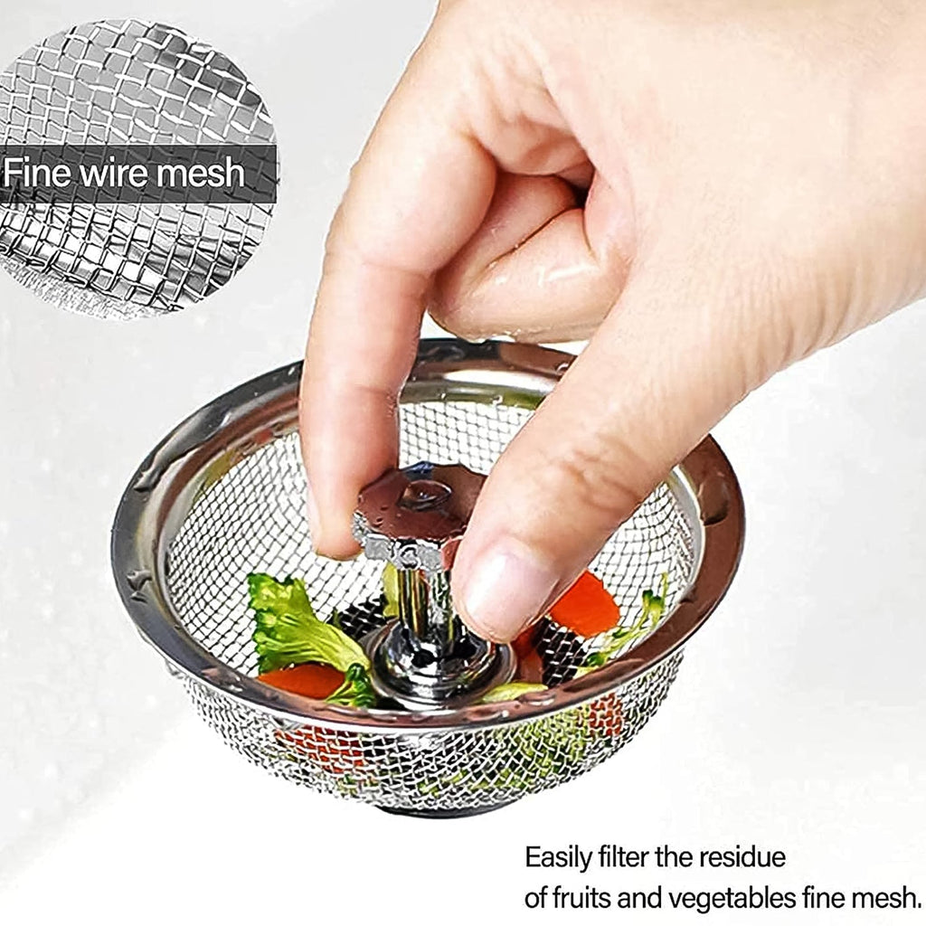 Stainless steel sink strainer in a kitchen basin, preventing food waste.