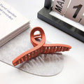 Durable plastic hair claw clips in mixed designs providing strong non-slip hold