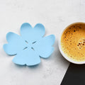A vibrant set of six heat resistant coasters displayed on a wooden table, ready to protect surfaces.