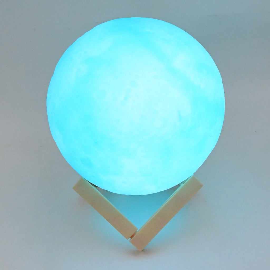 An elegant blue Moon Night Lamp casting a gentle glow, perfect for a cozy corner.