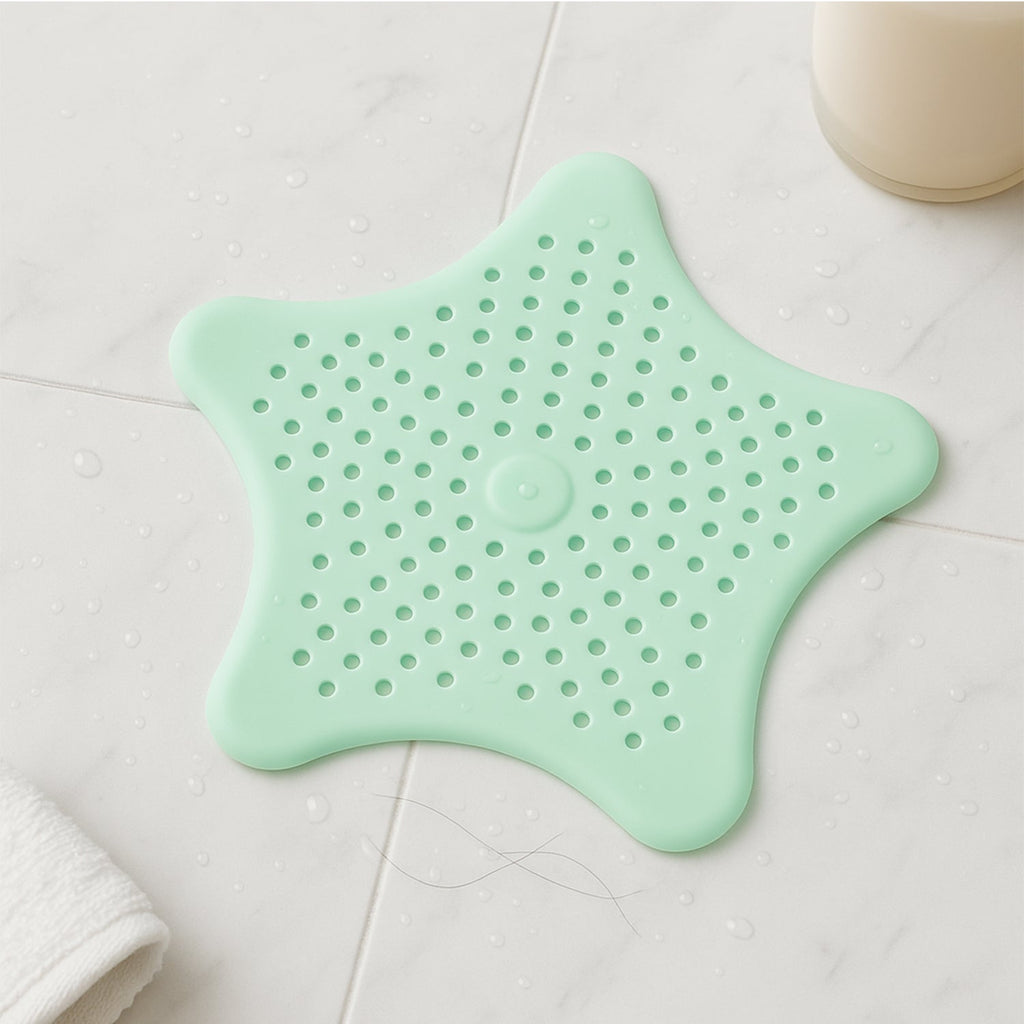 Mint green star sink hair catcher securely attached to bathroom tub drain