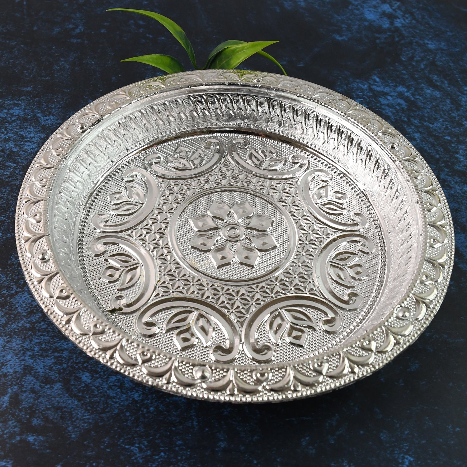 Silver finish plastic pooja thali with embossed floral design on surface