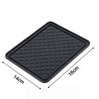 The non-slip anti-skid mat demonstrated holding small items firmly in place.