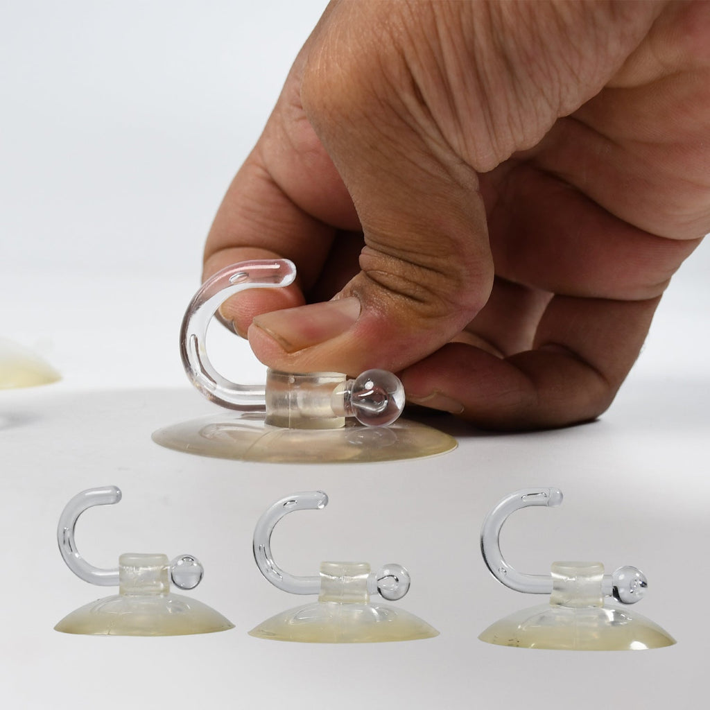 Clear suction hooks securely mounted on a window pane, perfect for lightweight items.
